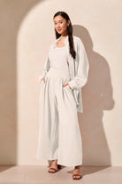 wide leg flowy pants in off hite and matching shirt worn by model