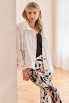 light coat jacket in white with print pants worn by model
