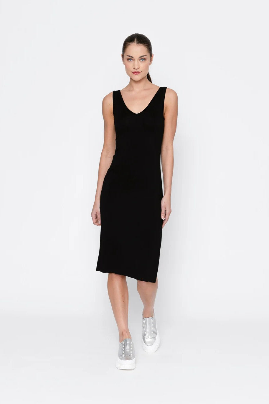 woman wearing black midi slip against white background