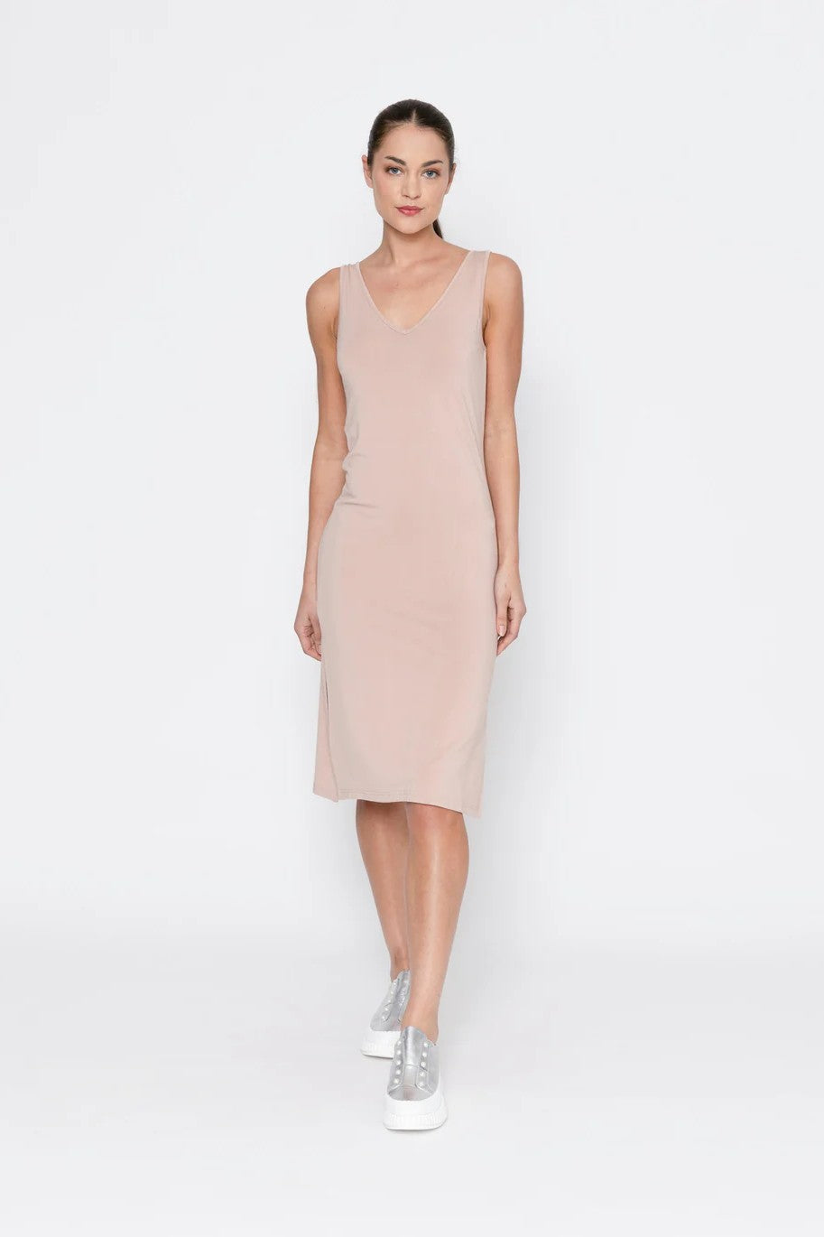 woman wearing beige midi slip against white background