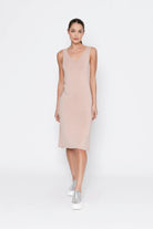 woman wearing beige midi slip against white background