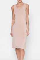 Beige sleeveless dress worn by a person on a white background