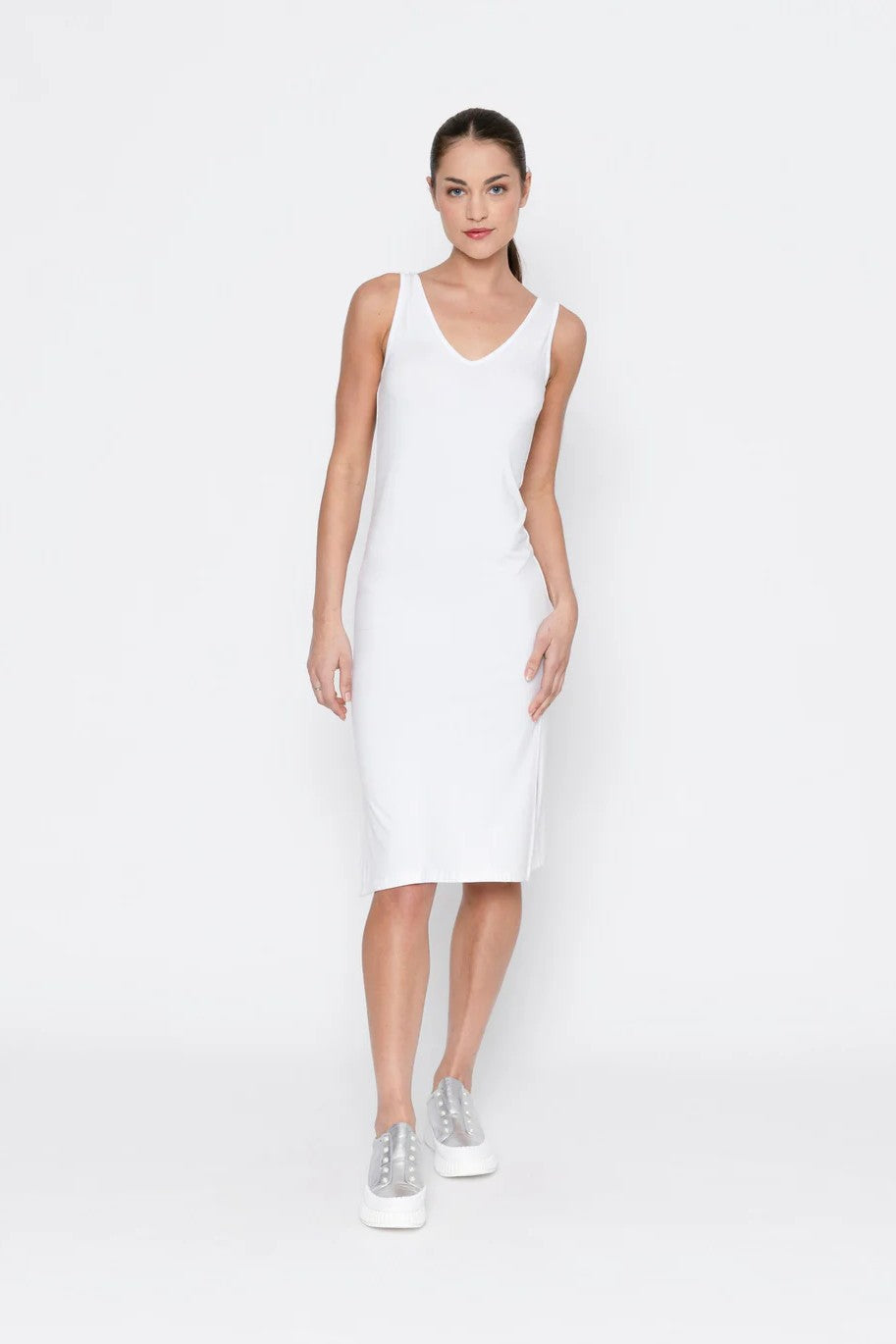 Woman wearing a white sleeveless dress on a white background