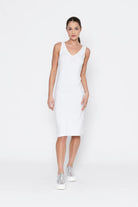 Woman wearing a white sleeveless dress on a white background