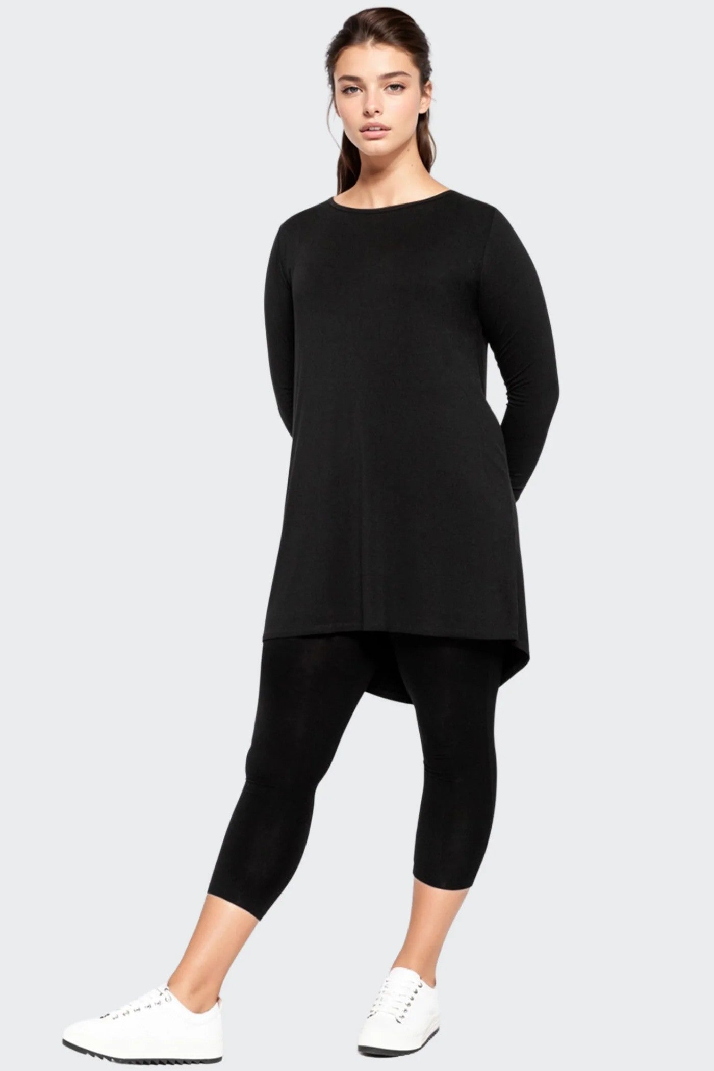 longline black top and black leggings worn by model