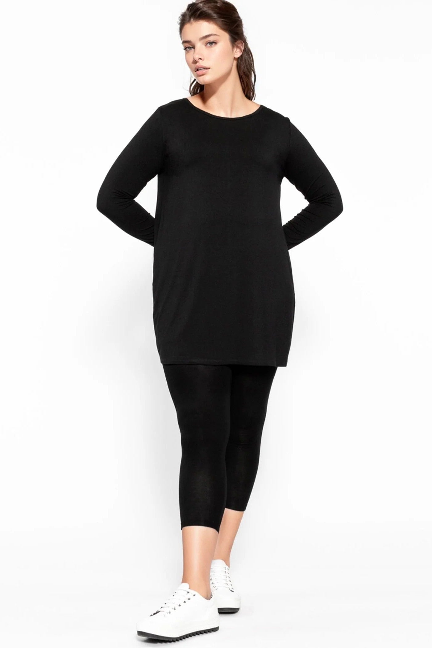 longline black top and black leggings worn by model
