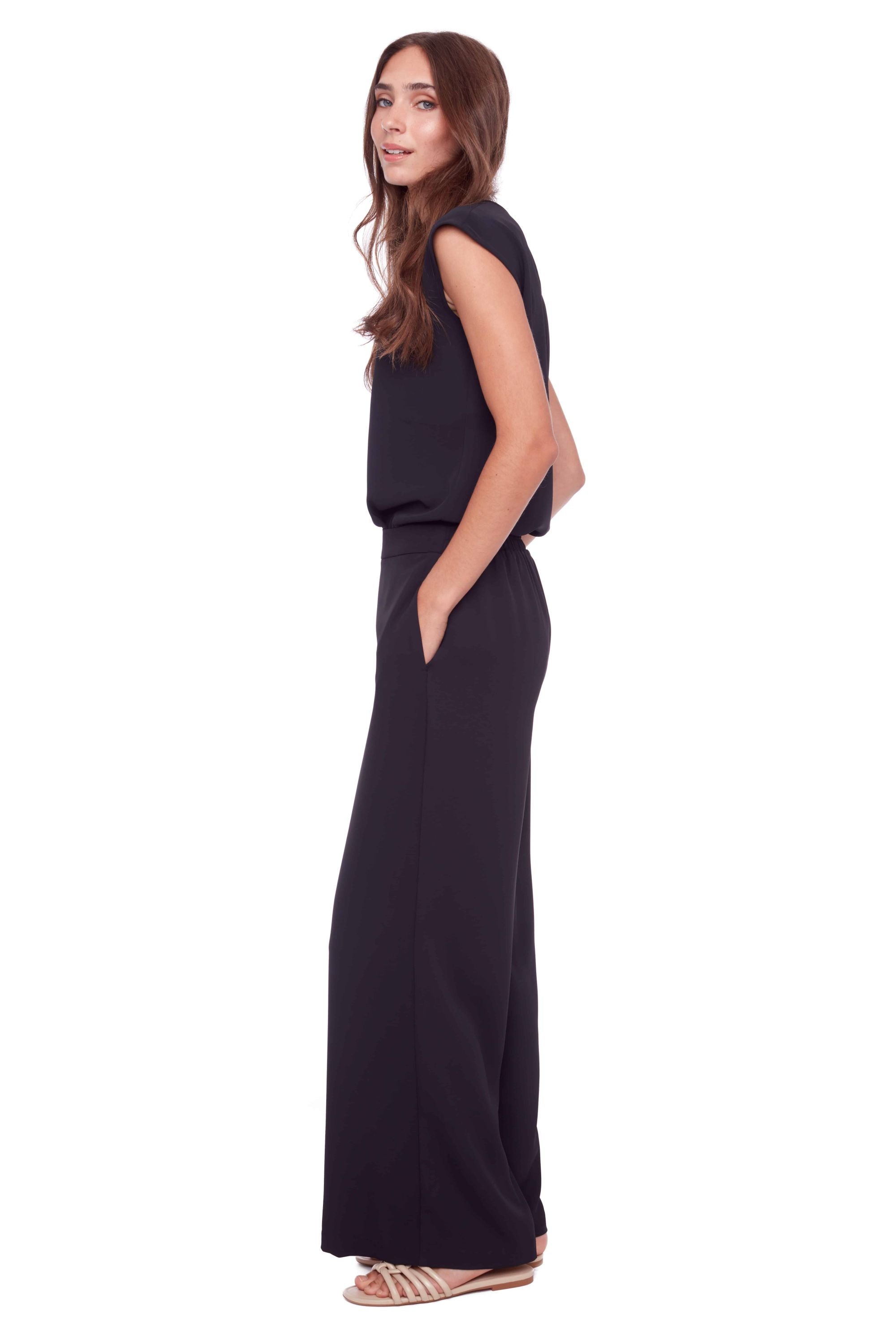 cap sleeve black top and wide leg pant worn by model side view