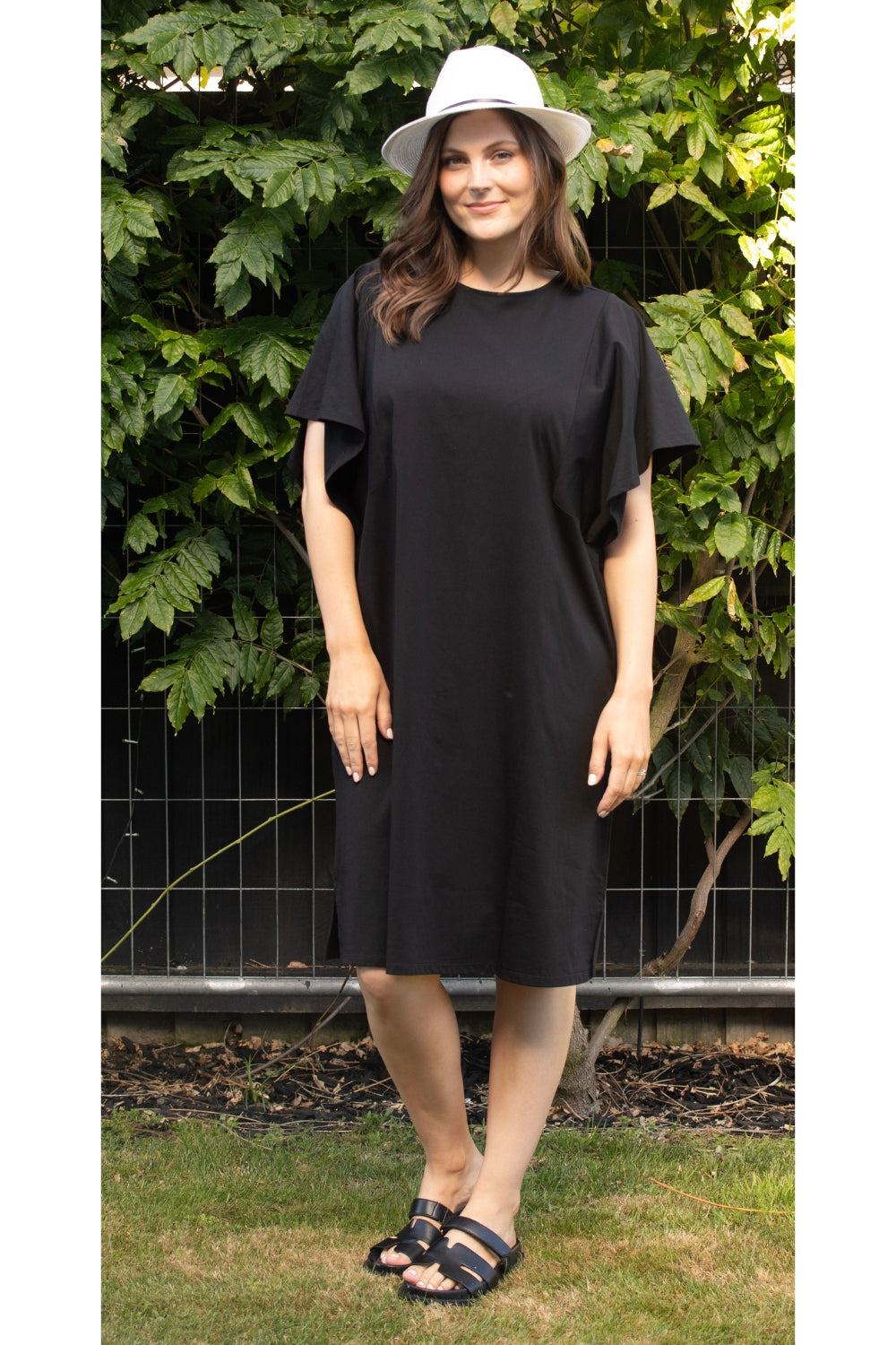 womens kne length midi black dress with flutter sleeves worn by model