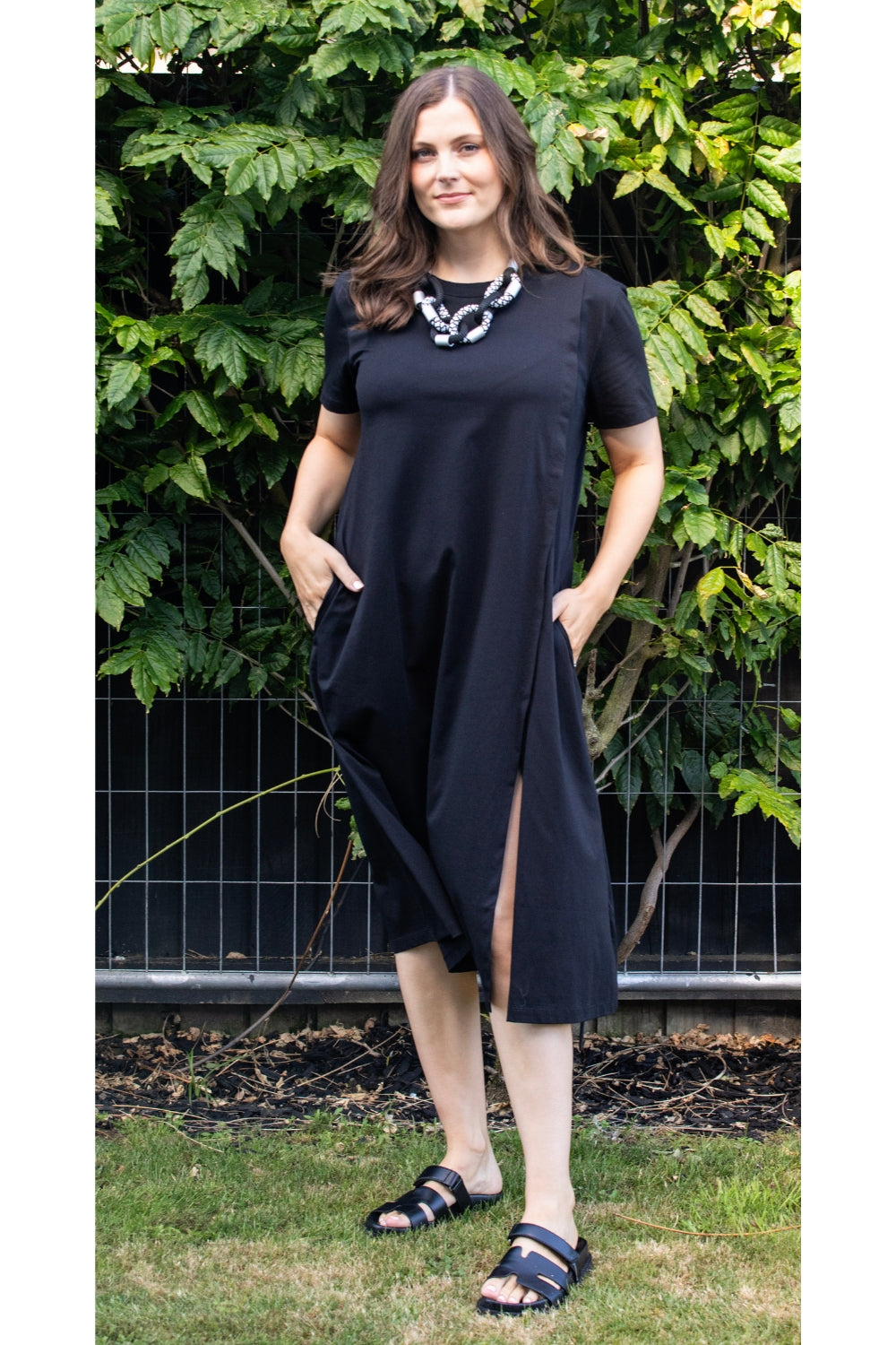 womens black midi dress with leg split worn by model