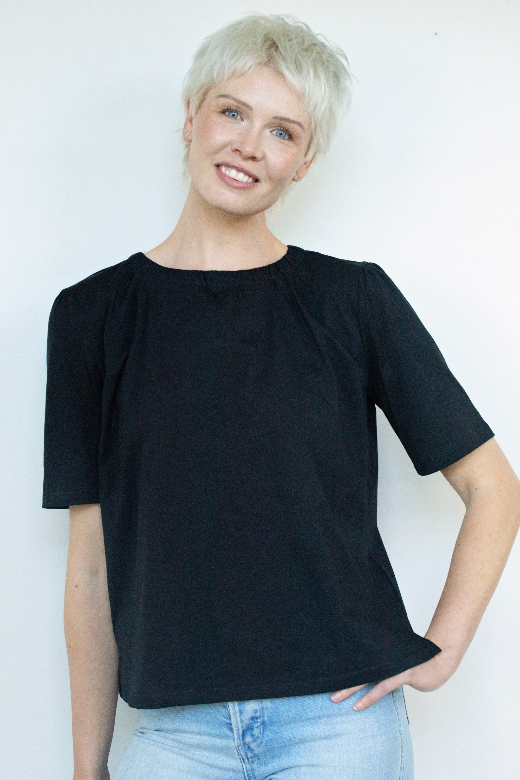 womens plain black tee with gathered neckline worn by model
