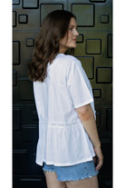 womens tee with gather detailing in white worn by model side view