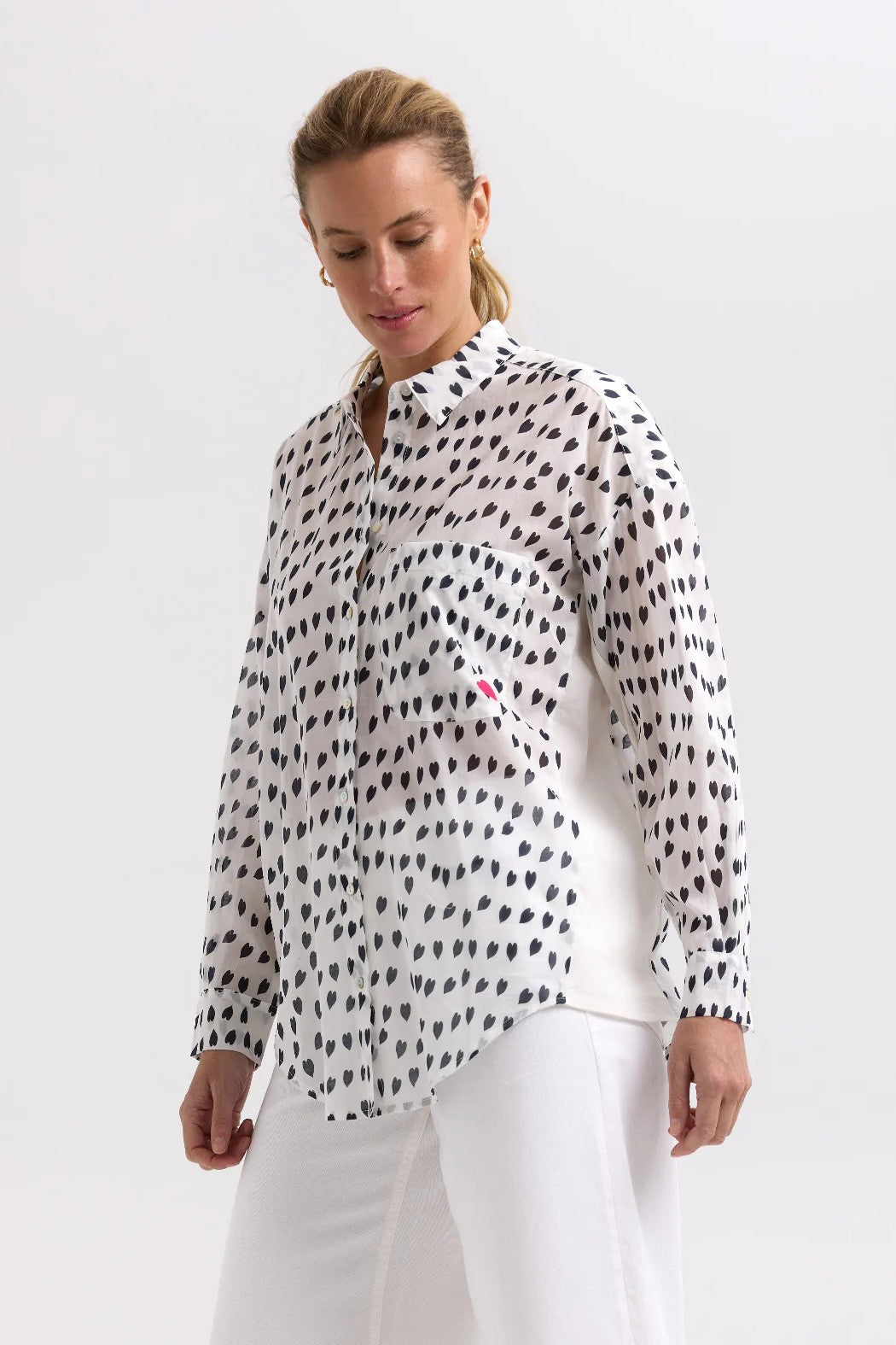 model wearing white shirt with black hearts