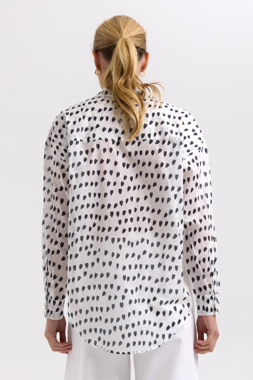 model wearing white shirt with black hearts back