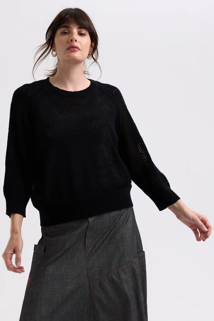 model wearing black sweater with heart sleeves 