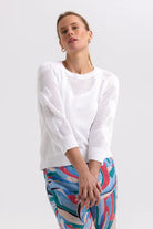 model wearing white sweater with heart sleeves 
