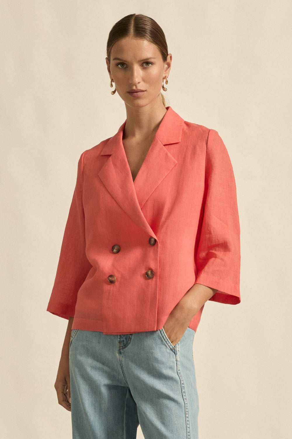 womens double breasted jacket in melon worn by model 