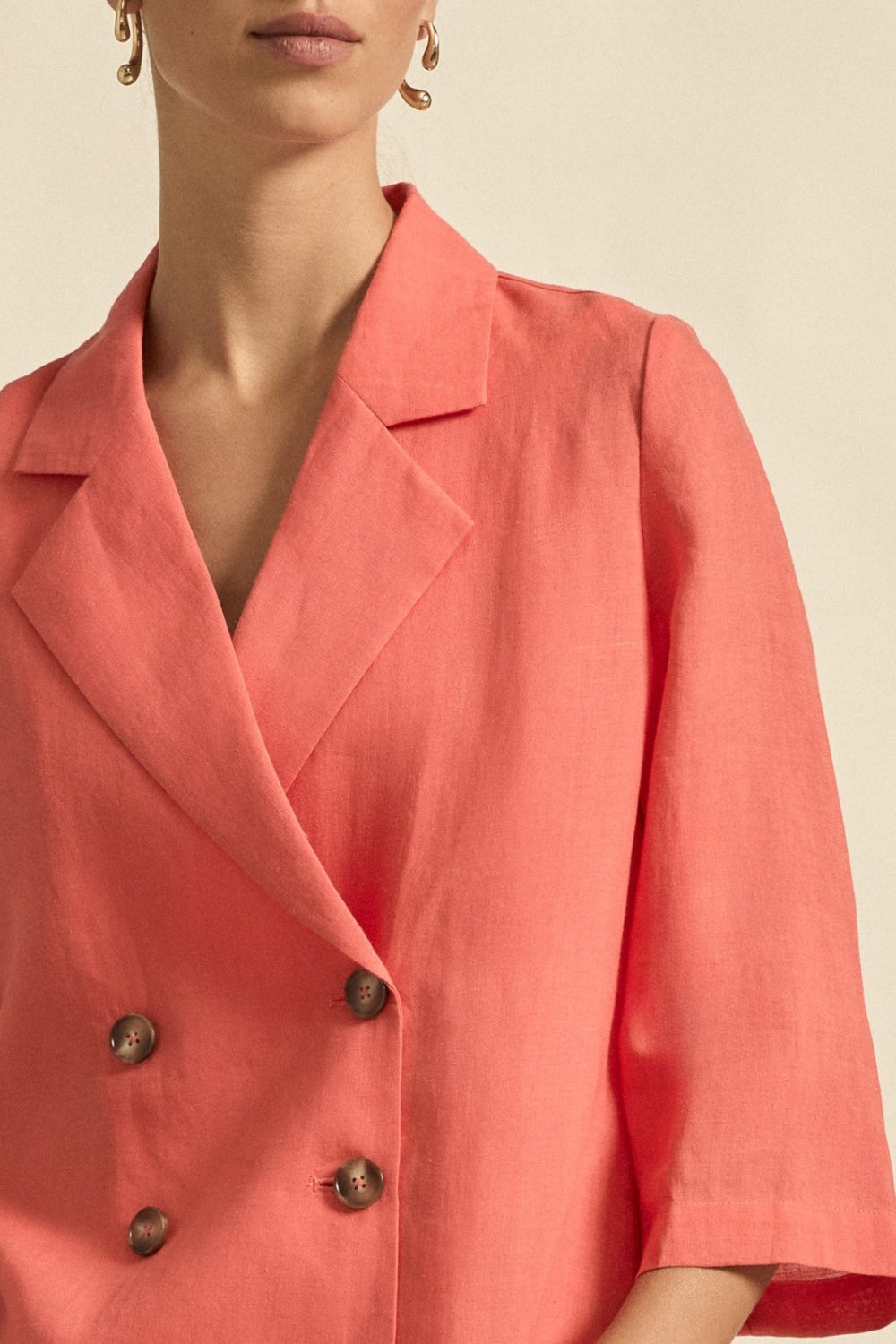 womens double breasted jacket in melon worn by model  close up