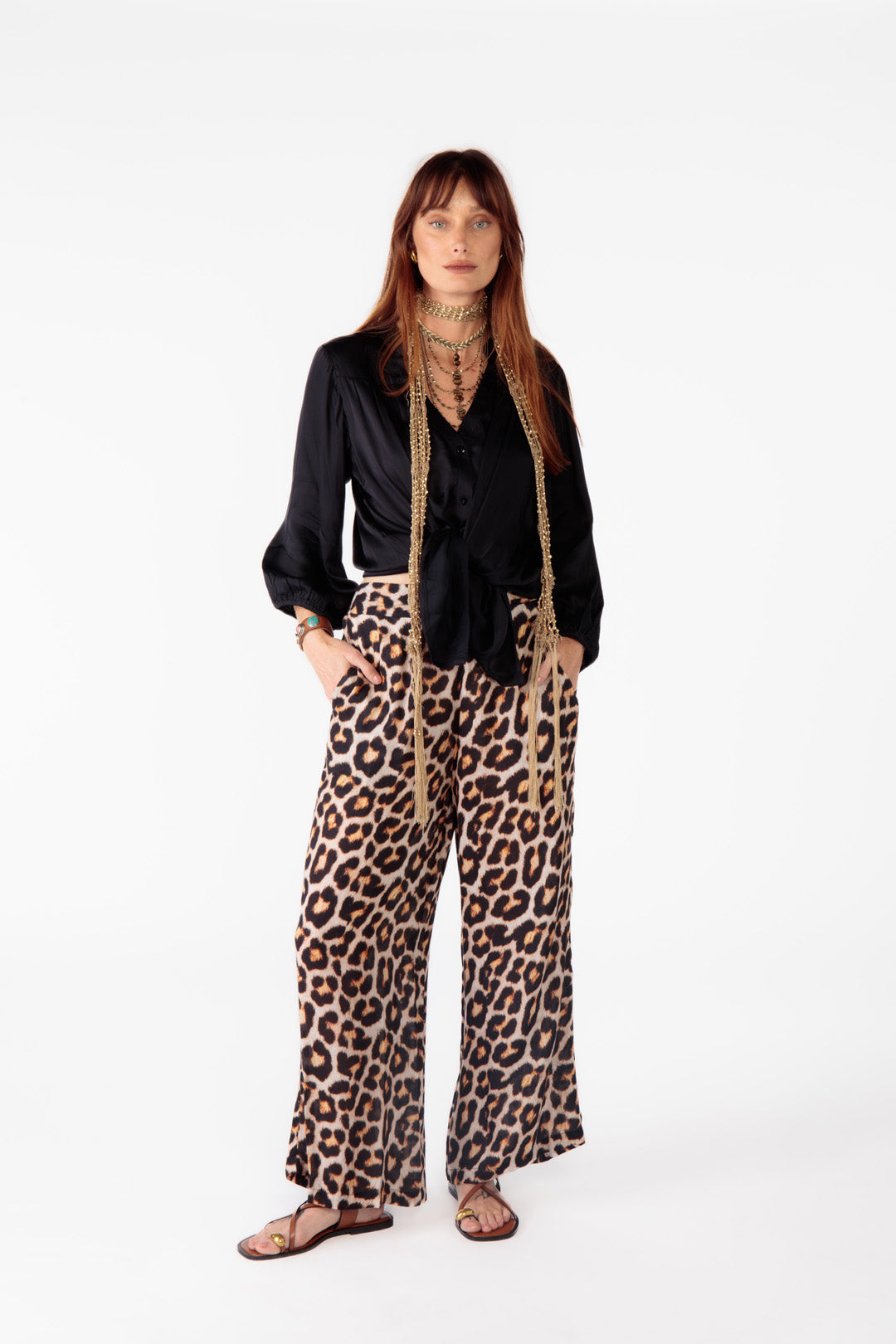 Black button-through shirt styled with leopard pants; woman poses in the Ruby Yaya Gabor Shirt by Ruby Yaya.