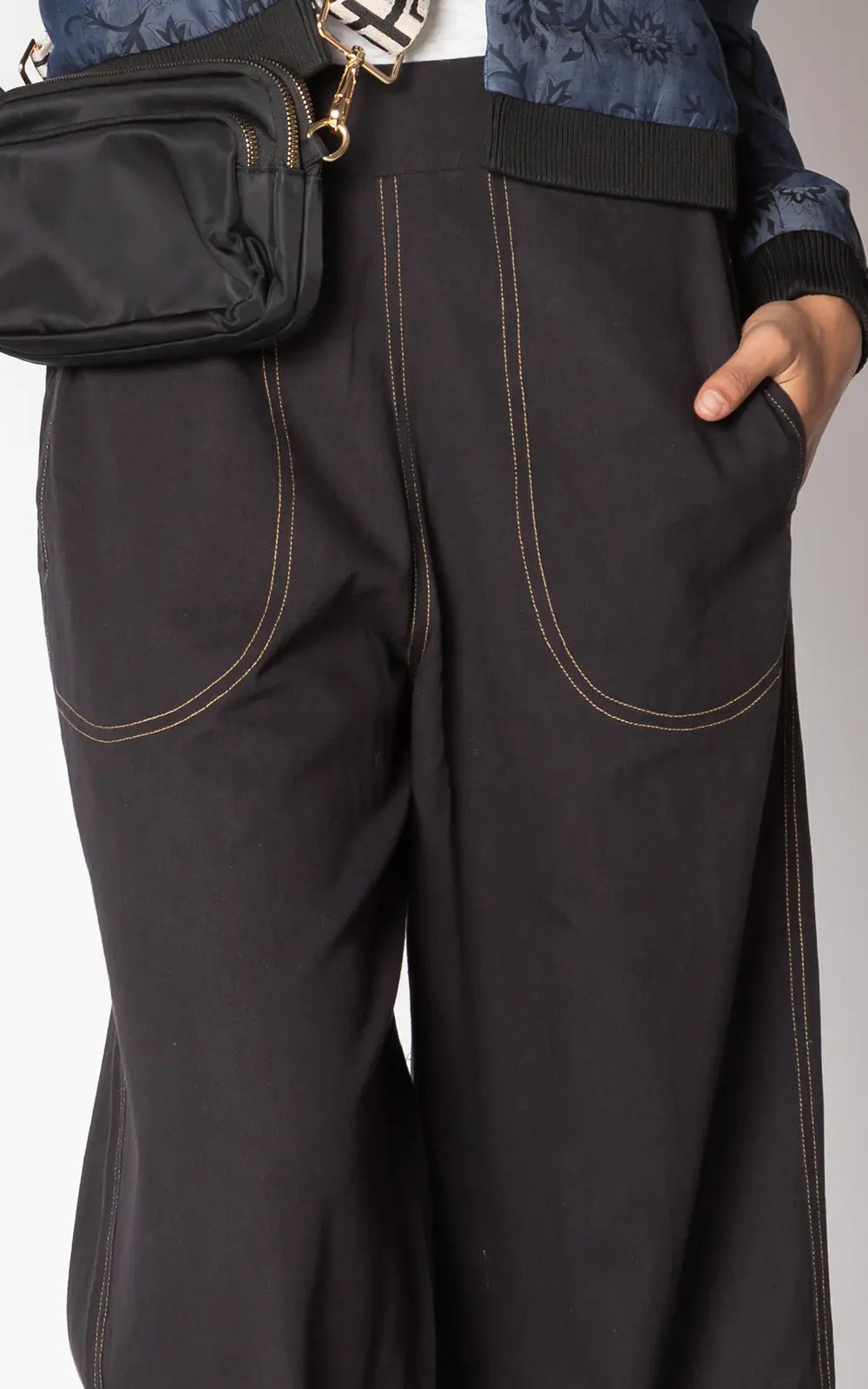 Close-up of side pocket and stitching detail on the black Ruby Yaya Pula Pant