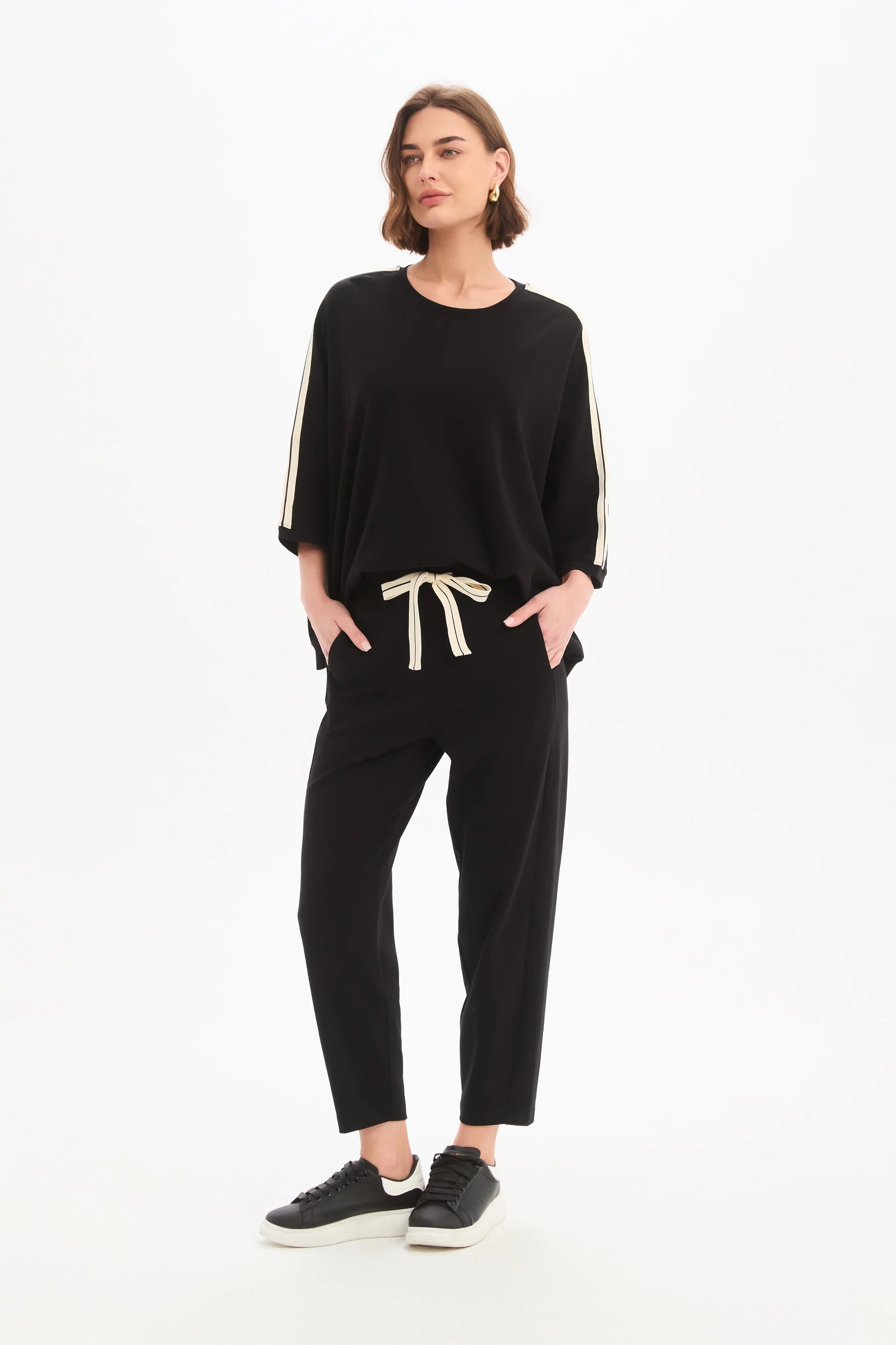 Woman wearing a black outfit with a white background