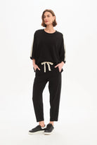 Woman wearing a black outfit with a white background