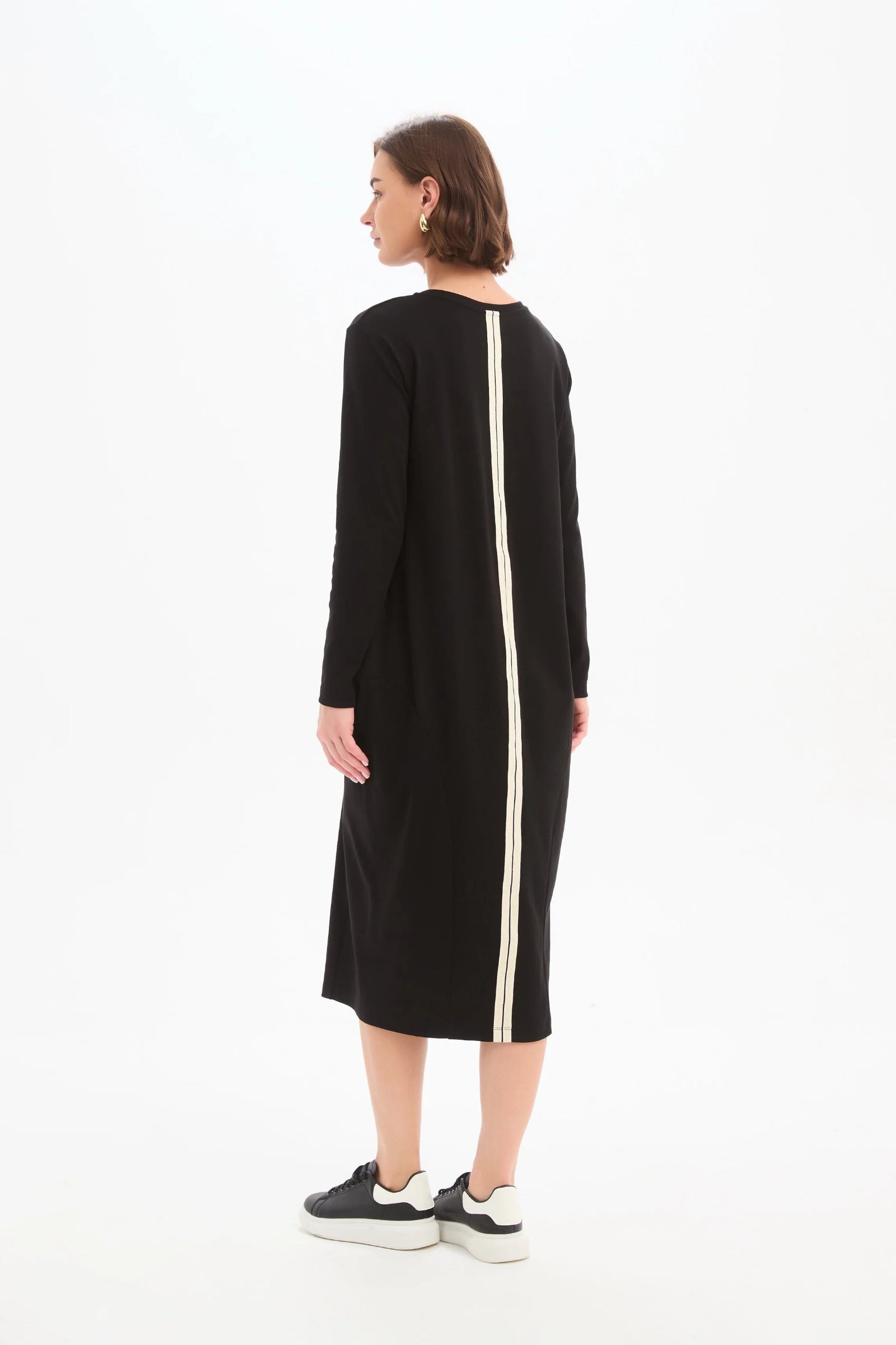 Black dress with a white stripe on a white background