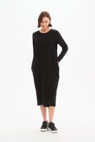 Woman wearing a black dress on a white background
