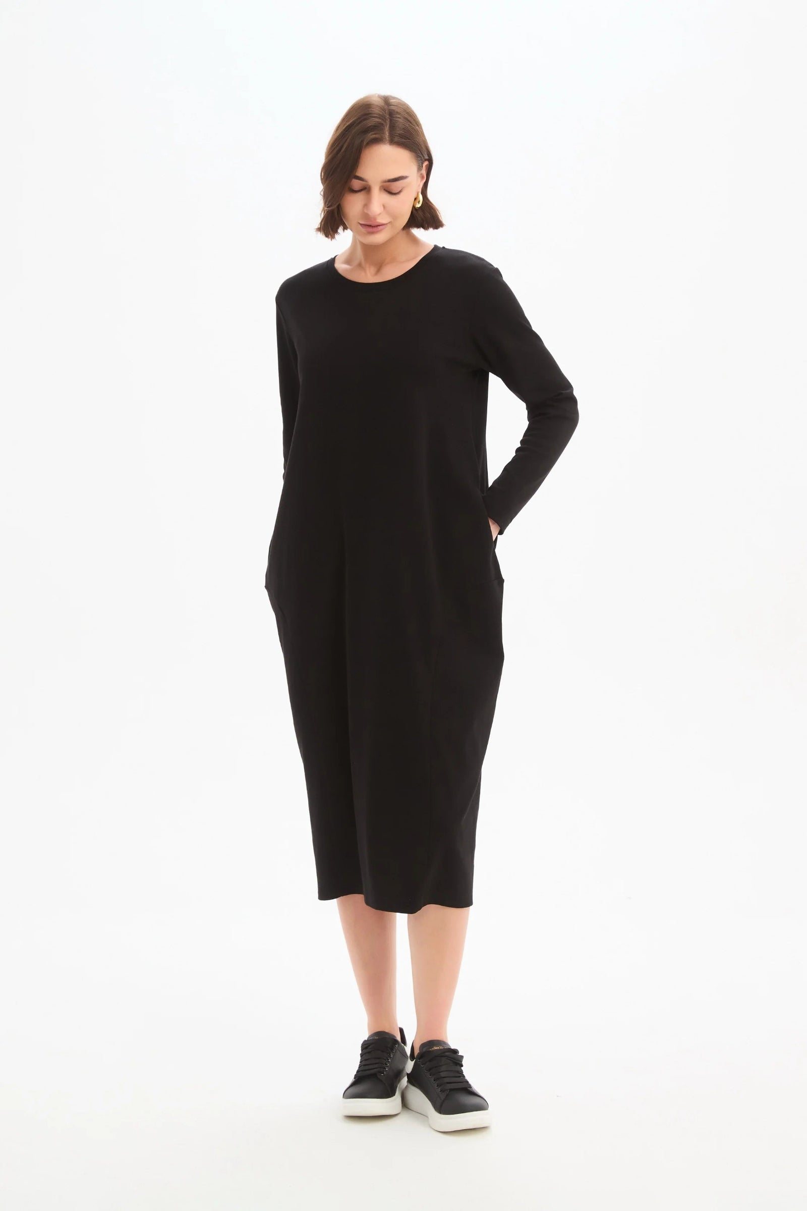 Woman wearing a black dress on a white background